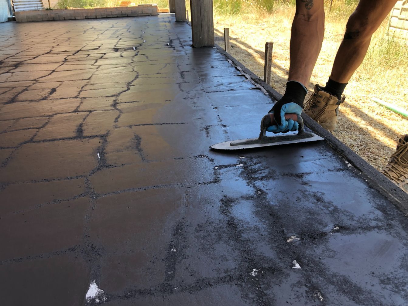 Concreters Bacchus Marsh finishing stenciled concrete at a job in Pentland Hills